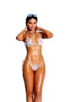 Lycra bikini top with ruffle trim and matching thong.